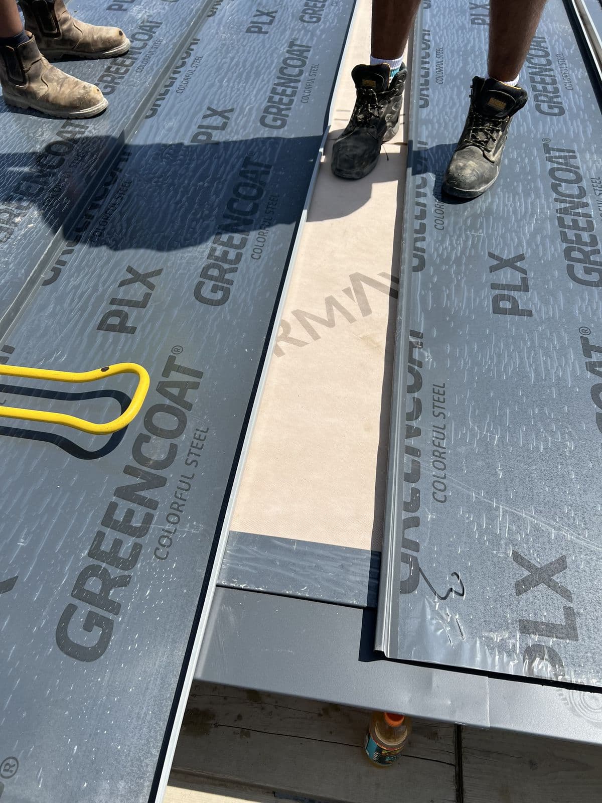 Steel roof sheets being fixed on an extension roof