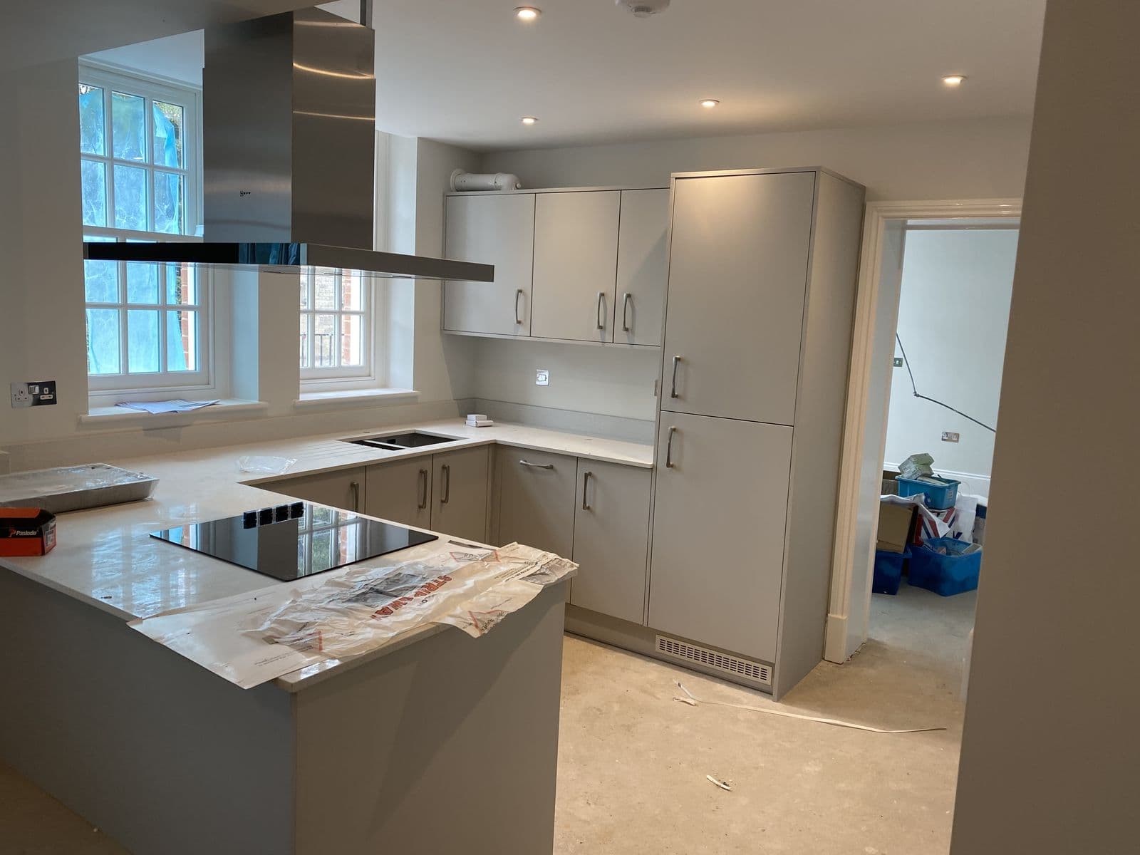 Grey shaker kitchen with island, induction hob and extractor